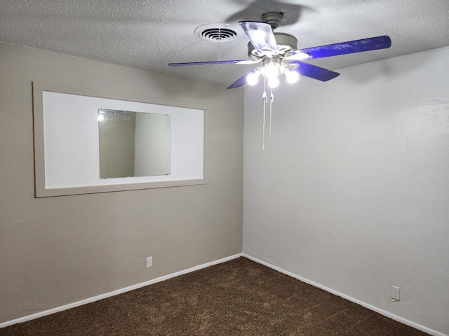 spare room with ceiling fan, carpet, and a textured ceiling