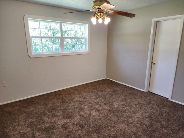 unfurnished room featuring ceiling fan, carpet floors, and a textured ceiling