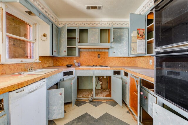 kitchen featuring sink, wooden counters, ventilation hood, dishwasher, and black oven