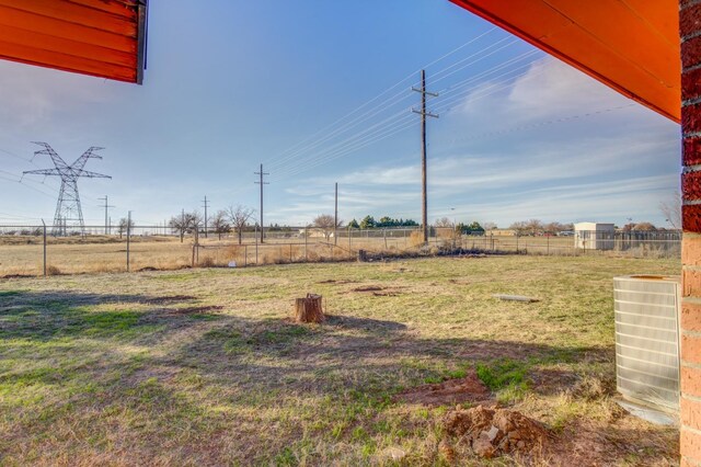 view of yard with a rural view and central AC unit