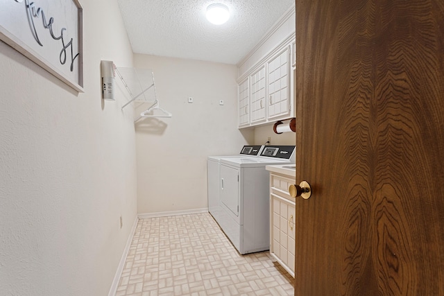 7007 Miami Ave, Lubbock, TX 79413 - laundry room with washer and dryer, a textured ceiling, cabinet space, and brick patterned flooring