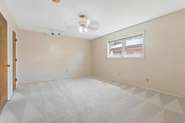 7007 Miami Ave, Lubbock, TX 79413 - unfurnished room with track lighting, a ceiling fan, light carpet, and a textured ceiling