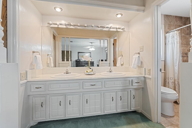 7007 Miami Ave, Lubbock, TX 79413 - bathroom with double vanity, ceiling fan, and curtained shower