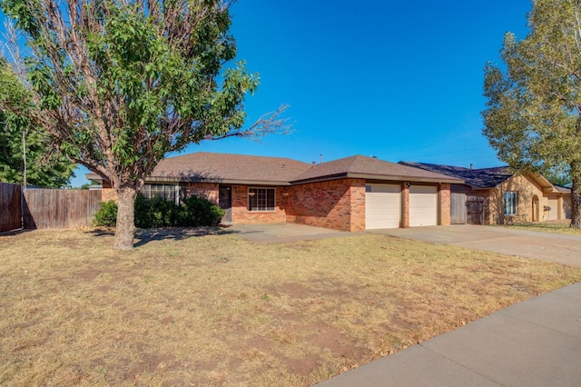 single story home featuring a garage and a front yard