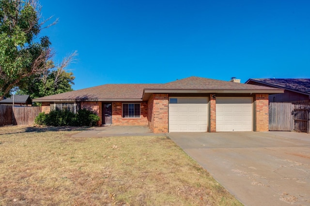 view of front of property featuring a garage and a front lawn