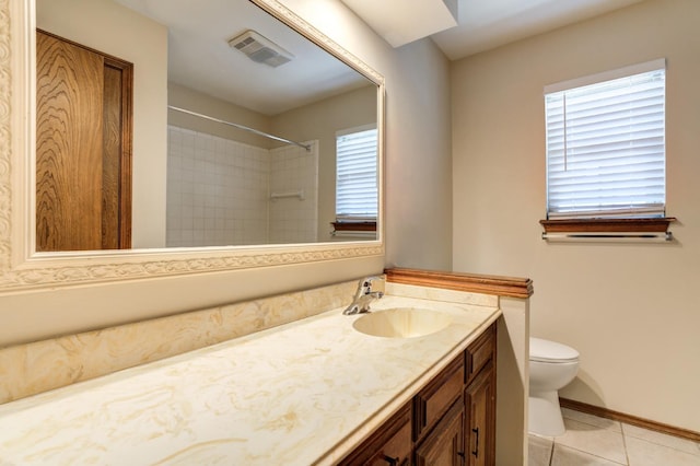 bathroom with tile patterned flooring, vanity, and toilet