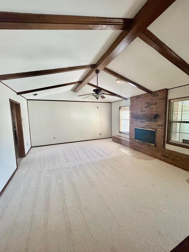 unfurnished living room featuring vaulted ceiling with beams, a fireplace, light colored carpet, and ceiling fan