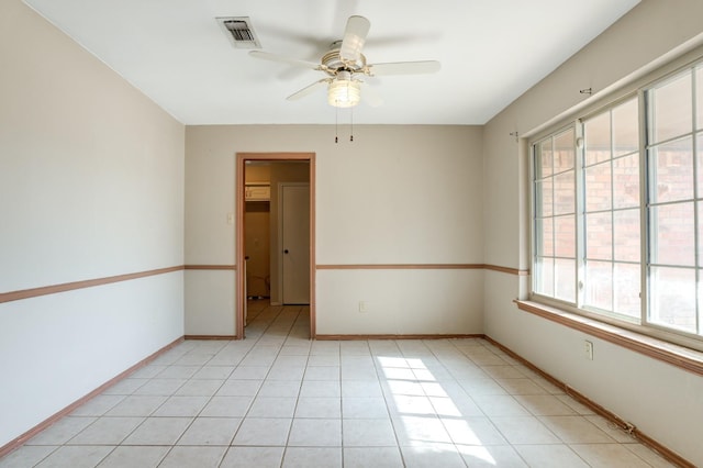 spare room with light tile patterned floors and ceiling fan