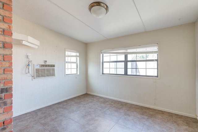 unfurnished room featuring an AC wall unit