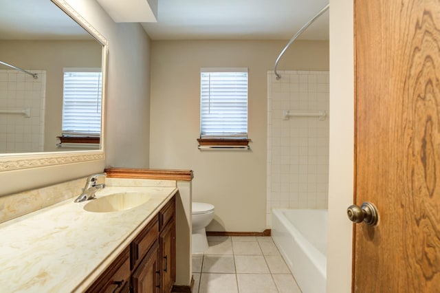 full bathroom featuring tiled shower / bath combo, vanity, tile patterned floors, and toilet