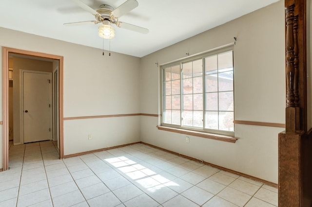 tiled spare room with ceiling fan