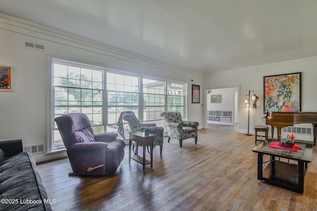 1901 31st St, Lubbock, TX 79411 - living room featuring wood finished floors, healthy amount of natural light, crown molding, and baseboards