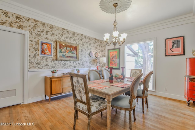 1901 31st St, Lubbock, TX 79411 - dining room with a chandelier, a wainscoted wall, light wood-style floors, baseboards, and wallpapered walls