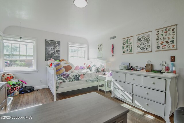 1901 31st St, Lubbock, TX 79411 - bedroom with multiple windows, wood finished floors, and baseboards