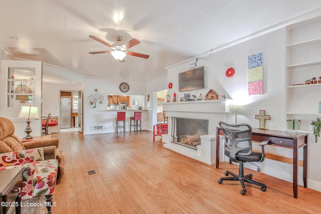 1901 31st St, Lubbock, TX 79411 - living area featuring ceiling fan, wood-type flooring, plenty of natural light, and a fireplace