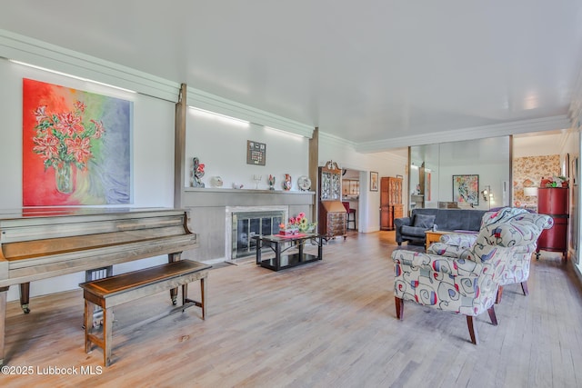 1901 31st St, Lubbock, TX 79411 - living area with wood finished floors, a fireplace with flush hearth, and ornamental molding