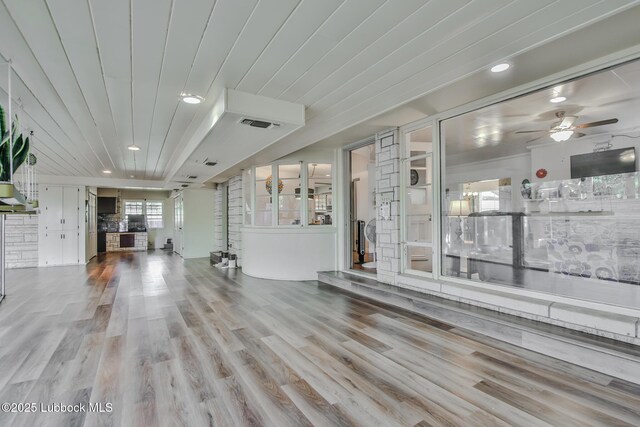 1901 31st St, Lubbock, TX 79411 - unfurnished living room featuring ceiling fan, wood finished floors, and recessed lighting