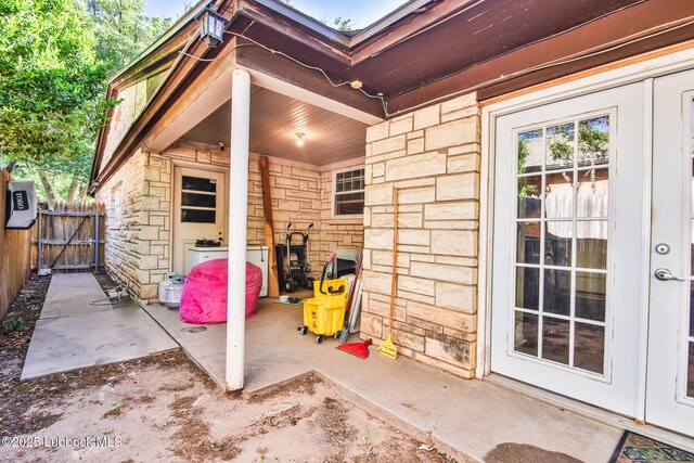 1901 31st St, Lubbock, TX 79411 - view of exterior entry featuring stone siding, a patio, and a gate