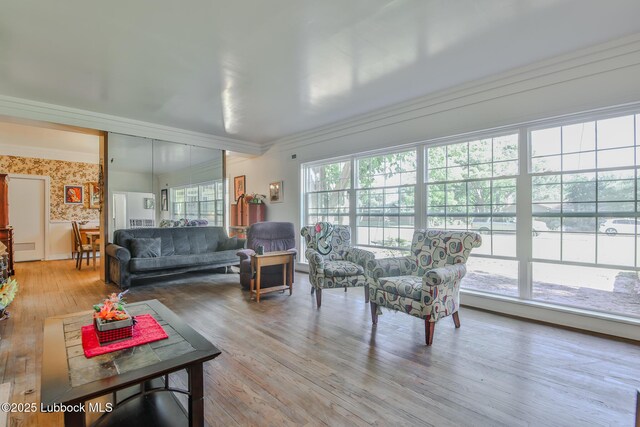 1901 31st St, Lubbock, TX 79411 - living area featuring wood finished floors, crown molding, and wallpapered walls