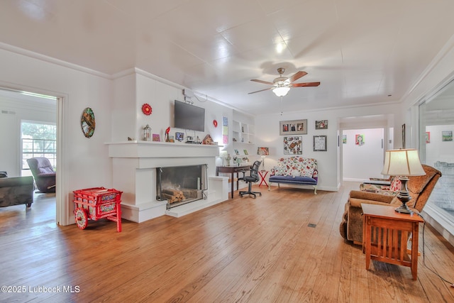 1901 31st St, Lubbock, TX 79411 - living area with a ceiling fan, light wood-type flooring, a glass covered fireplace, and ornamental molding