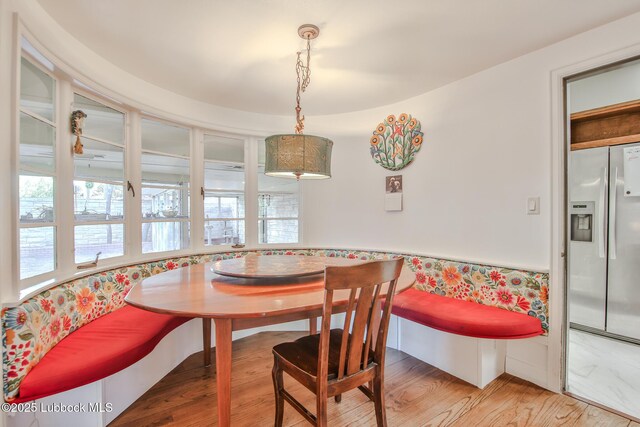 1901 31st St, Lubbock, TX 79411 - dining room featuring wood finished floors, breakfast area, plenty of natural light, and a wainscoted wall