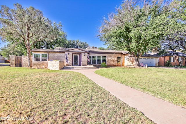 1901 31st St, Lubbock, TX 79411 - ranch-style home with a front yard, stone siding, and an attached garage