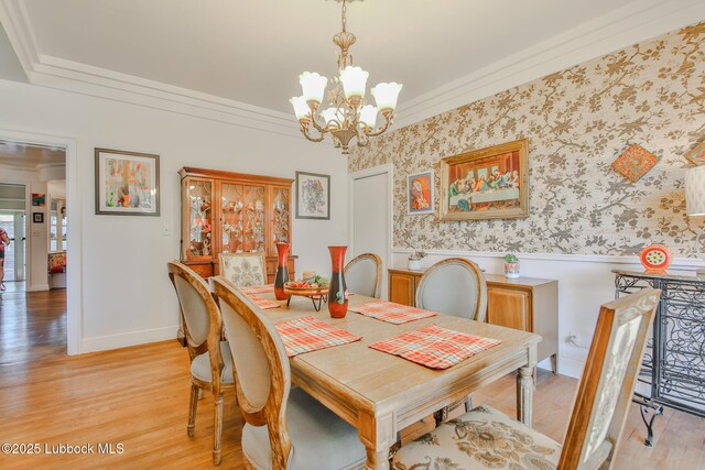 1901 31st St, Lubbock, TX 79411 - dining area featuring a chandelier, a wainscoted wall, light wood-style floors, crown molding, and baseboards