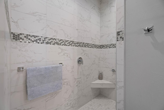 full bath with a tile shower