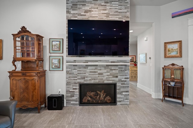 living room featuring a fireplace and baseboards