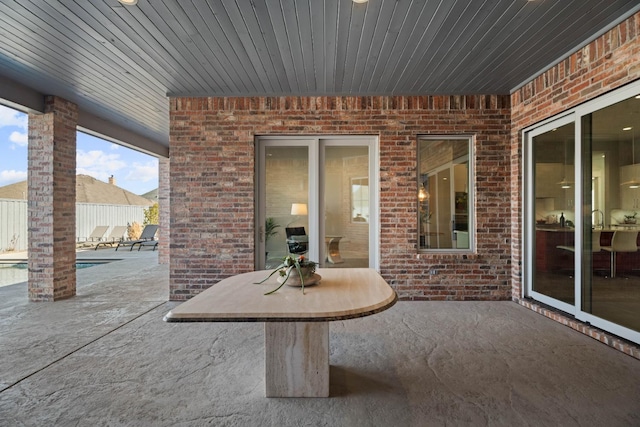 view of patio featuring fence and a fenced in pool