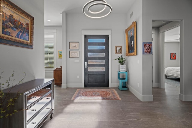 foyer entrance featuring visible vents and baseboards