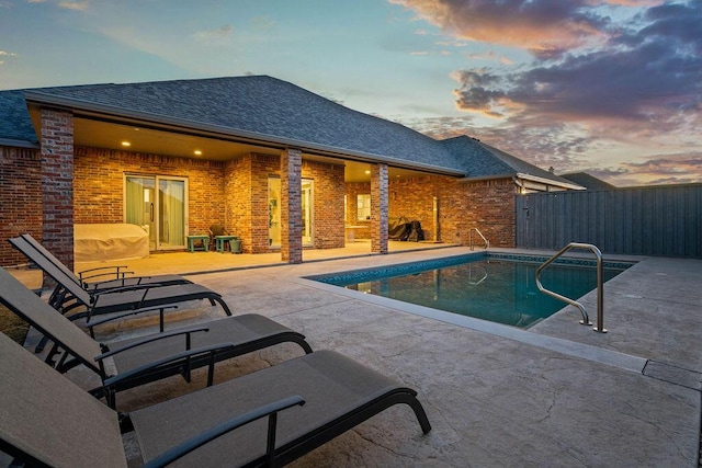 view of swimming pool with a fenced in pool, a patio area, and fence