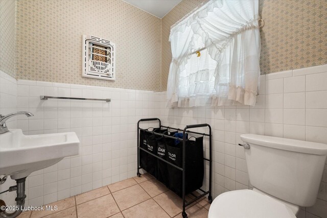 5426 28th St, Lubbock, TX 79407 - half bath with wainscoting, tile walls, tile patterned flooring, and wallpapered walls