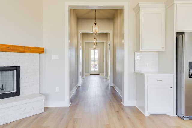 hallway with light hardwood / wood-style floors