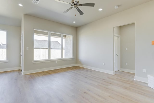 empty room with ceiling fan and light hardwood / wood-style floors