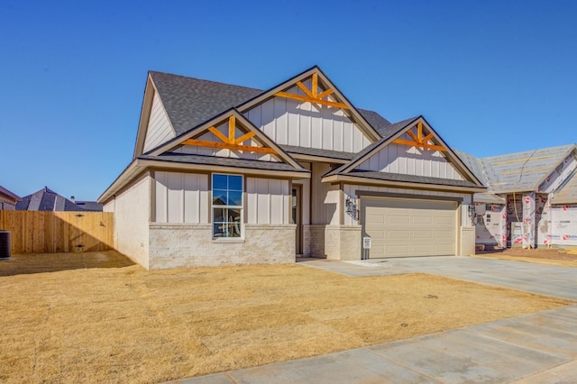 view of front of house featuring central AC and a garage