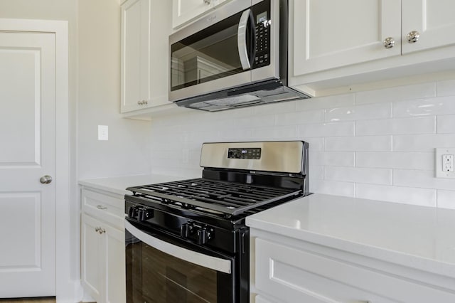 kitchen featuring white cabinetry, appliances with stainless steel finishes, and backsplash