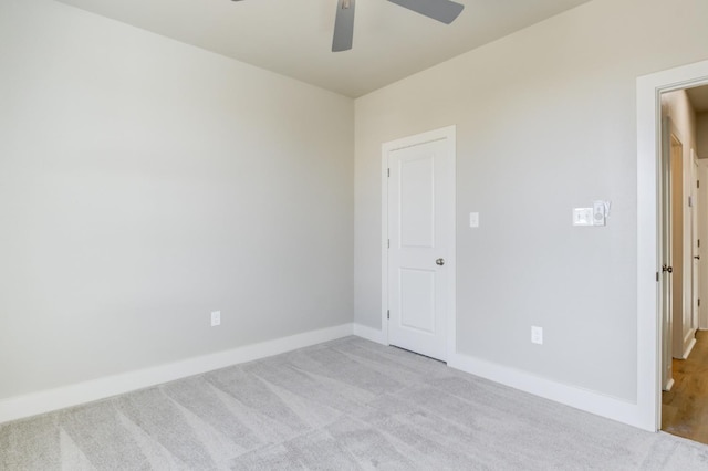 carpeted spare room with ceiling fan