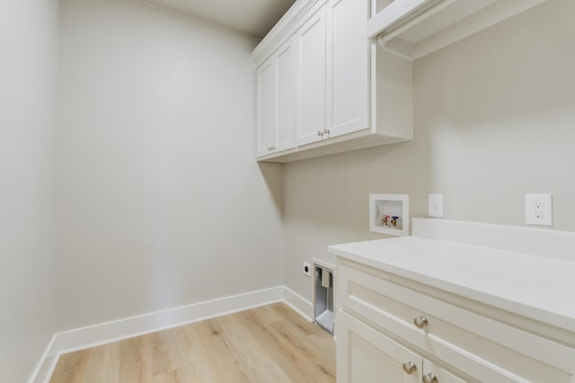 laundry room featuring cabinets, hookup for a washing machine, hookup for an electric dryer, and light hardwood / wood-style flooring