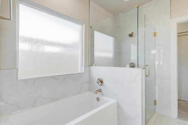 bathroom featuring separate shower and tub