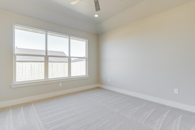 unfurnished room featuring ceiling fan, lofted ceiling, and light carpet