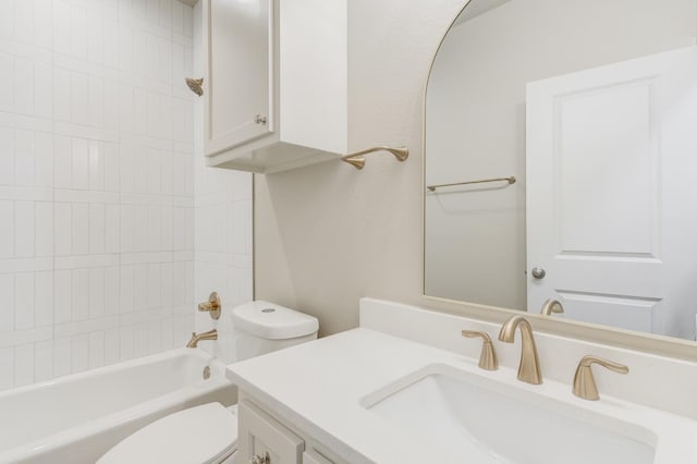 full bathroom with vanity, tiled shower / bath combo, and toilet