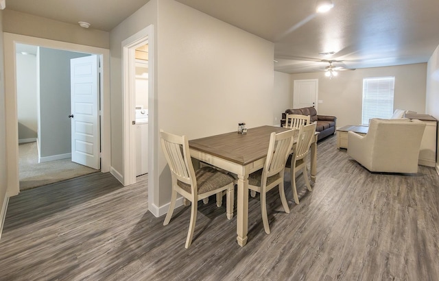 dining space with ceiling fan and dark hardwood / wood-style floors