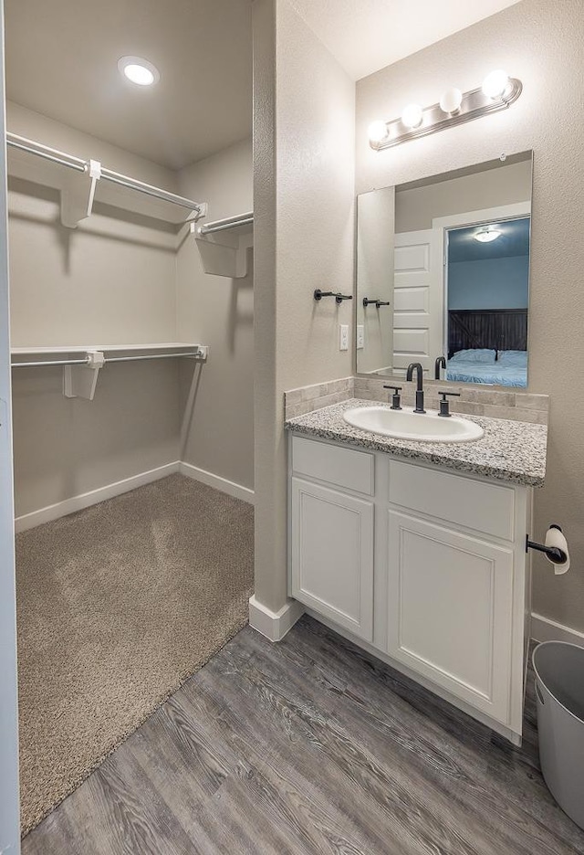 bathroom with hardwood / wood-style flooring and vanity