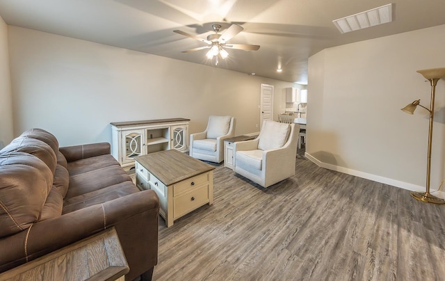 living room featuring hardwood / wood-style floors and ceiling fan