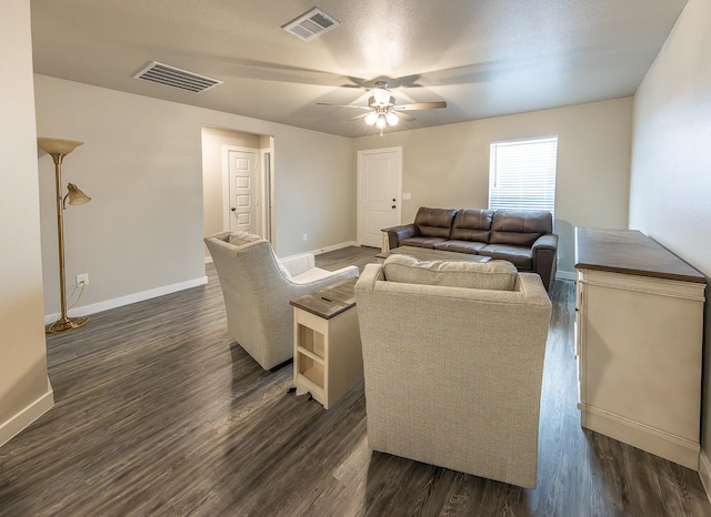 living room with dark wood-type flooring and ceiling fan