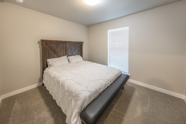 bedroom with dark colored carpet