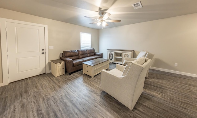 living room featuring ceiling fan and dark hardwood / wood-style floors