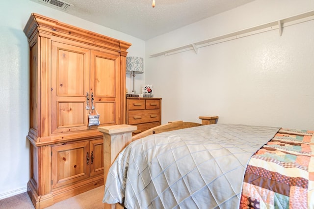 carpeted bedroom with a textured ceiling