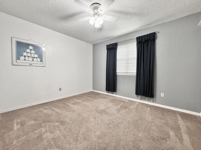 carpeted spare room with ceiling fan and a textured ceiling